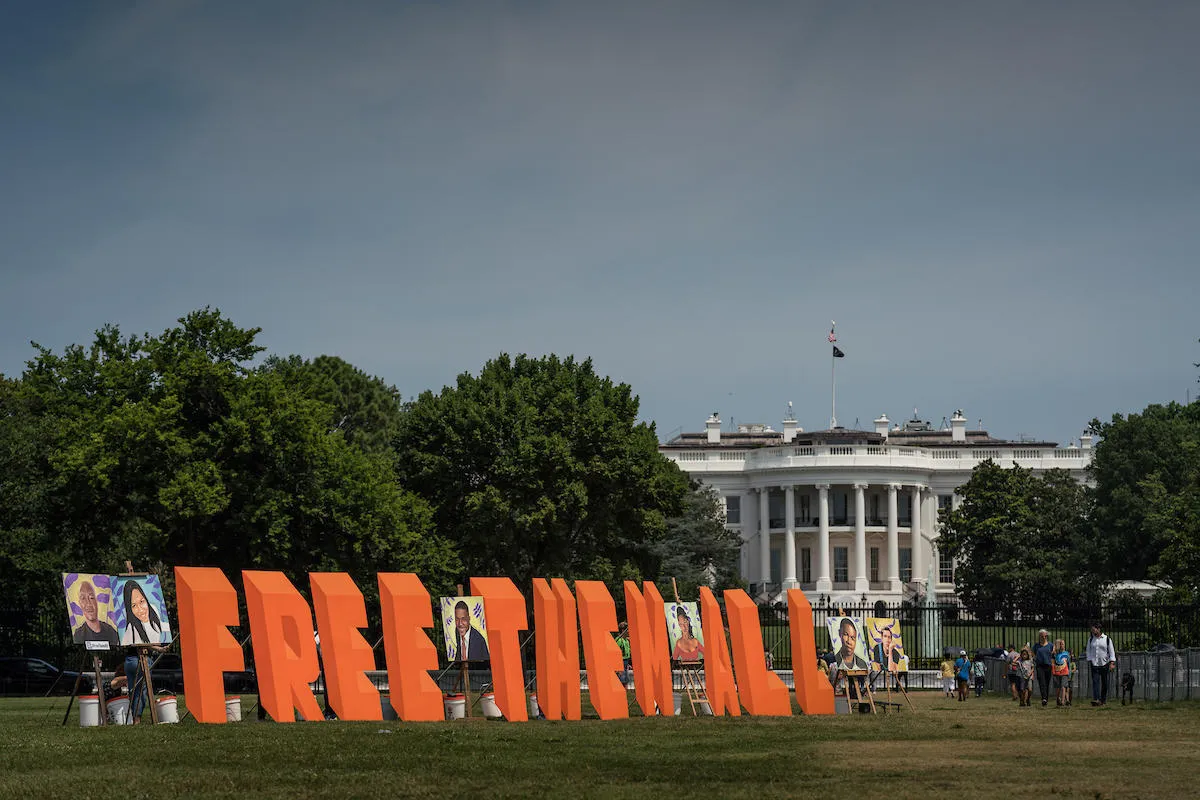 Free Them All signage in front of the White House